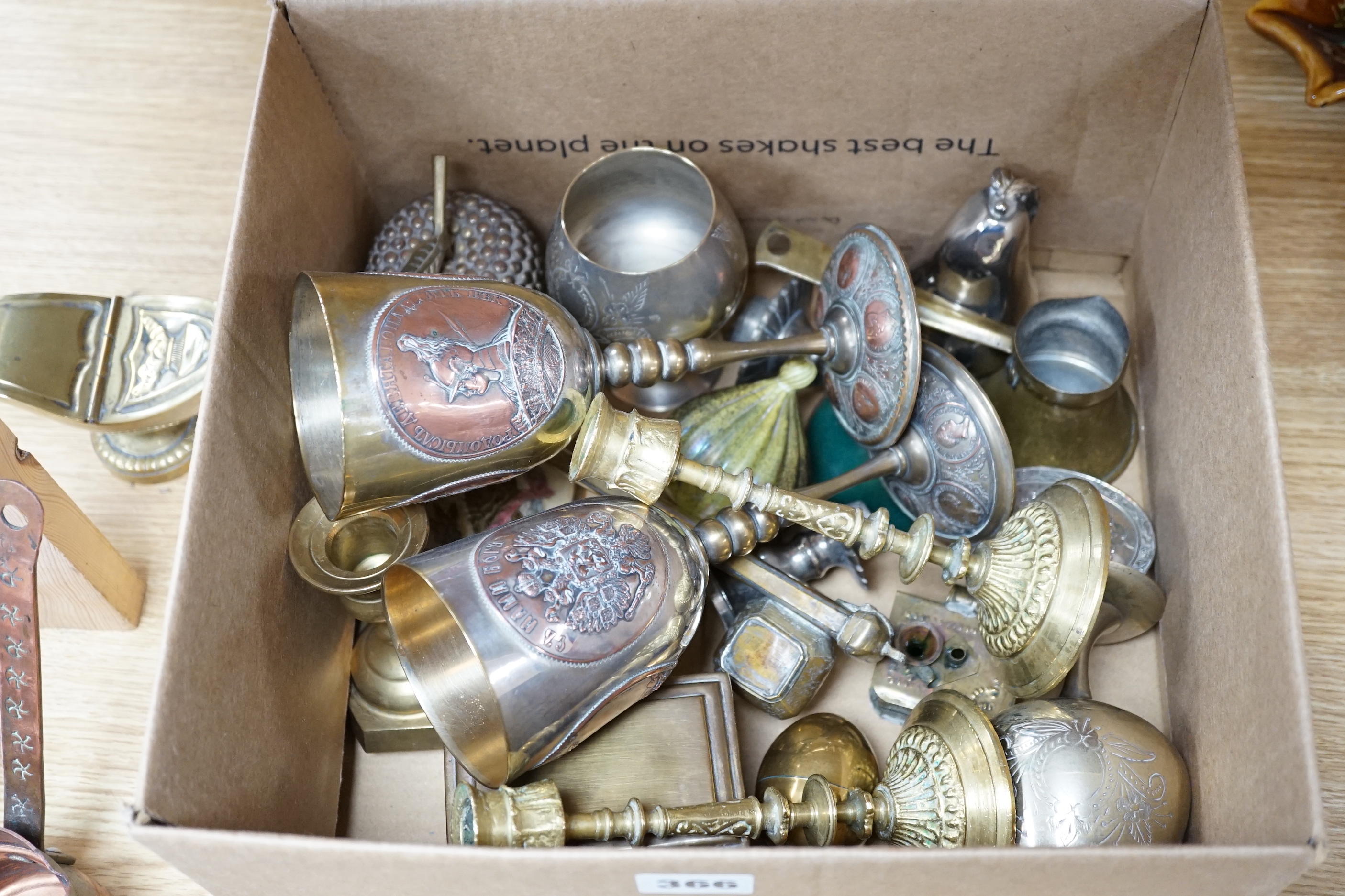 A group of mixed metalware including a pair of brass candlesticks, a brass bound book slide, iron keys, etc.